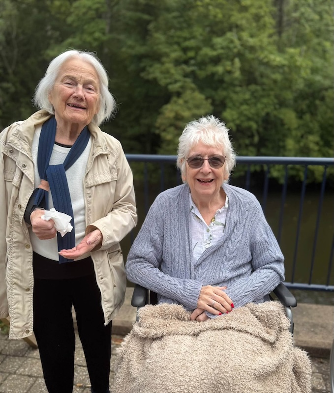 two care residents sitting by riverside